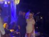 GOSSIP99 : Perrie Edwards poses in her second wedding dress and a dramatic veil as she kicks off her bridal heels while being serenaded with remix of Marry You at wild party