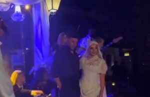 GOSSIP99 : Perrie Edwards poses in her second wedding dress and a dramatic veil as she kicks off her bridal heels while being serenaded with remix of Marry You at wild party